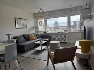 a living room with a couch and a table at Oland Whg 3 Bi de Meere in Wyk auf Föhr