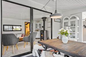 a living room with a wooden table and two dogs at 8223-Vordingborg-Laekrogen-13 in Vordingborg