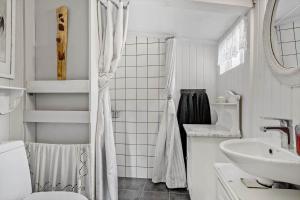 a white bathroom with a shower and a sink at 8223-Vordingborg-Laekrogen-13 in Vordingborg +13 photos