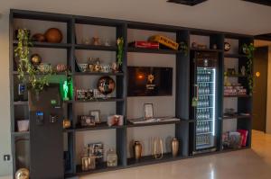 a room with a wall filled with shelves at gambino hotel CINCINNATI in Munich