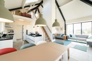 a kitchen and living room with a table and chairs at Hestia (8p) in Nes