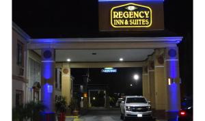 a car parked in front of a parking garage at Regency Inn & Suites Houston East I 10 in Houston