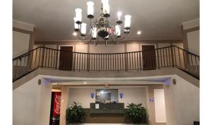 a chandelier in the middle of a lobby at Regency Inn & Suites Houston East I 10 in Houston