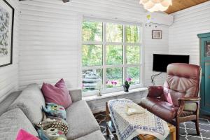 a living room with a couch and a chair and a window at 2025-Stege-Ulvshalevej-319 in Stege