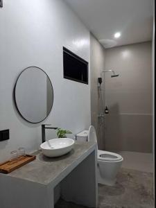 a bathroom with a sink and a toilet and a mirror at Second Point View BK in Batukaras