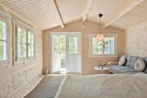 a room with a couch and a table and windows at 2025-Stege-Ulvshalevej-319 in Stege