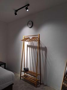 a room with a clock on the wall and a wooden stand at Second Point View BK in Batukaras +1 photo