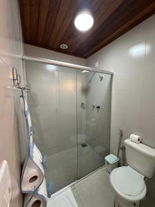 a bathroom with a glass shower and a toilet at Chalé Vila Catarina in Ouro Preto +17 photos