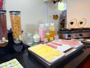 a kitchen with meat and other food items on a counter at Pousada Papito Ubatuba - Praia Perequê-Açu in Ubatuba