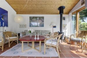 a living room with a table and chairs at 3055-Stege-Stejlepladsen-23 in Stege +12 photos