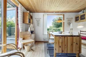 a kitchen with a wooden island in a room at 3055-Stege-Stejlepladsen-23 in Stege