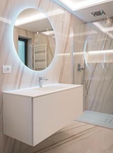 a bathroom with a white sink and a mirror at Seaside Resort in Santa Croce Mare +38 photos