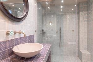 a bathroom with a tub and a sink and a mirror at Alistos Hotel in Gythio +82 photos