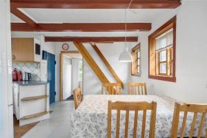 a kitchen and dining room with a table and chairs at S705-Stroby-Hybenvej-1 in Strøby +14 photos