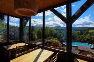 a dining room with a view of the mountains at Chata Jaga in Szklarska Poręba