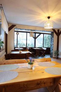 a large wooden table in a room with a large window at Chata Jaga in Szklarska Poręba