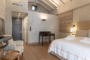 a bedroom with a bed and a table and a couch at Alistos Hotel in Gythio
