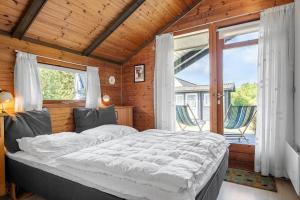 a bedroom with a large bed and a large window at 3046-Stege-Paelen-46 in Stege