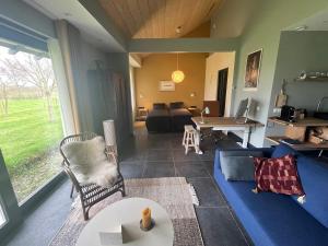 a living room with a couch and a table at In de Hemmele bij Maria in Lievelde