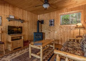 a living room with a wood stove in a cabin at Pinewood - Bouchard Shores Resort in Minocqua