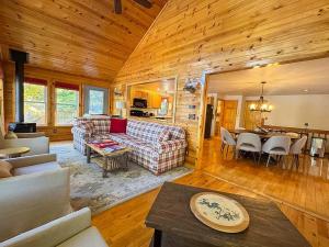 a living room with a couch and a table at Hilltop - Bouchard Shores Resort in Minocqua