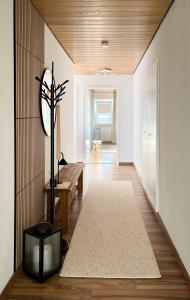 a hallway of a house with a bench and a mirror at De Bookholt - Premium Ferienwohnung in Vreden