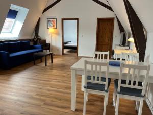 a living room with a white table and chairs at Weingärtner Appartements in Mannheim
