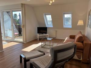 a living room with a couch and a tv at Weingärtner Appartements in Mannheim