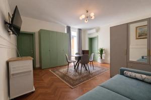 a living room with a couch and a table and chairs at Residence Corte Bizantina in Ravenna