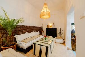 a living room with a couch and a table at Riad Taww'Ami in Marrakesh +32 photos