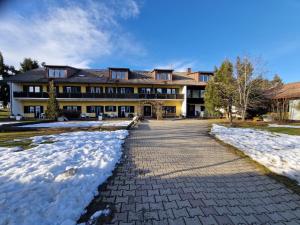 a large building with snow in front of it at Ferien- und Reiterhof Ochsenkopf in Missen-Wilhams