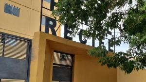a building with a sign on the side of it at Hotel Recife in Ciudad del Este