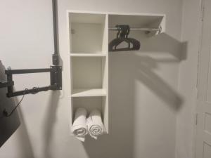 a towel rack with two pairs of shoes in a closet at Hotel Giselle Boutique in Boa Vista