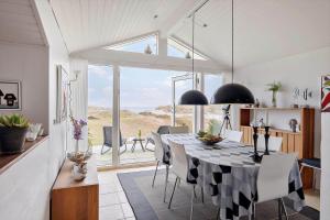 a dining room with a black and white table and chairs at HA344-Saeby-Annesvej-1 in Sæby +20 photos