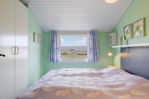 a bedroom with a bed and a window at HA344-Saeby-Annesvej-1 in Sæby