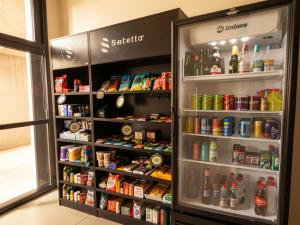 a refrigerator filled with lots of food and drinks at Xtay Vila Madalena - Stay close to everything with an outdoor pool and access to the best coworking spaces in Vila Madalena in São Paulo