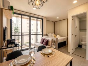 a apartment living room with a bed and a dining table at Xtay Vila Madalena - Stay close to everything with an outdoor pool and access to the best coworking spaces in Vila Madalena in São Paulo +18 photos