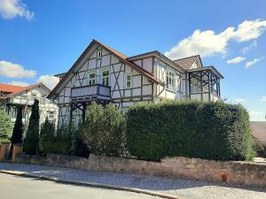 a large house sitting on the side of a street at Ferienwohnung Berthold WG 6 in Blankenburg +7 photos