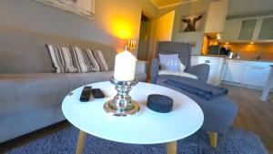 a living room with a table with a candle on it at Beachhouse in Eckernförde