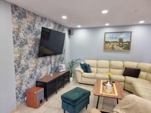 a living room with a couch and a tv at Biały Zakątek in Trzebnica
