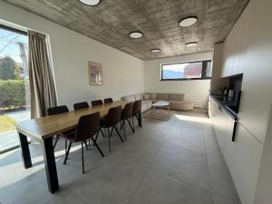 a dining room with a long table and chairs at Jamy House in Habovka