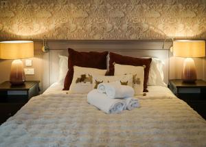 a bedroom with a bed with towels on it at Redmire Village Pub in Redmire +30 photos