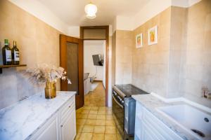 a large kitchen with a sink and a tub at Casa Caramello in Faggeto Lario  +44 photos