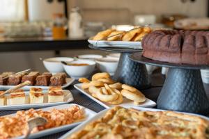 a buffet of different types of pastries and breads at Alistos Hotel in Gythio