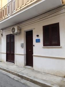 a building with two doors on the side of a street at Almía apartment in Cinisi