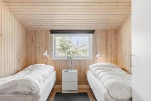 two beds in a room with a window at OH156-Hadsund-Halvrebene-26 in Hadsund