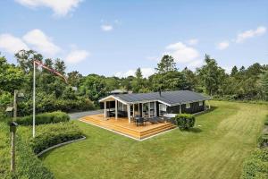 a small house with a deck on a field at OH156-Hadsund-Halvrebene-26 in Hadsund