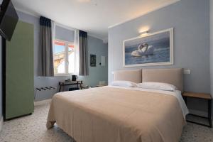 a bedroom with a large bed and a window at Residence Corte Bizantina in Ravenna