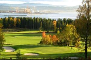 a golf course with a view of the water at Scandic Stiklestad in Verdal