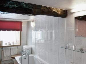 a bathroom with a sink and a bath tub at Sherrifs Lodge - Hw7730 in Llangadog +2 photos